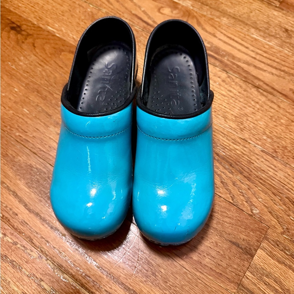 Teal sanita clogs.
